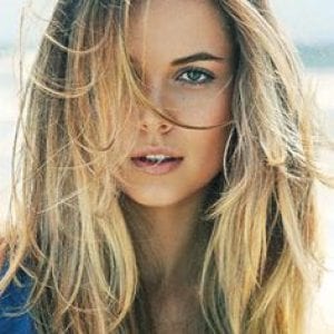 Close-up of a woman with sun-kissed balayage hair, showcasing the natural, low-maintenance hair color technique offered at Adore Atlanta.